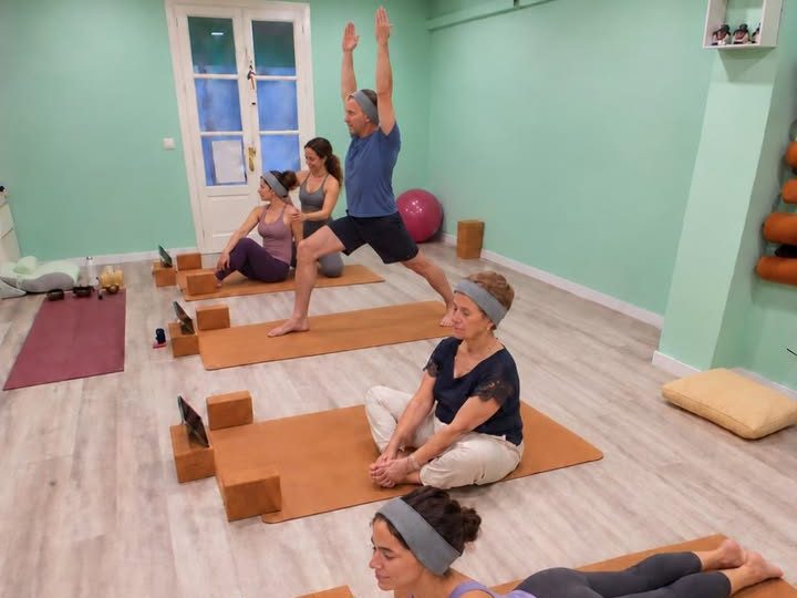 Class in the green aqua room, each student on her mat